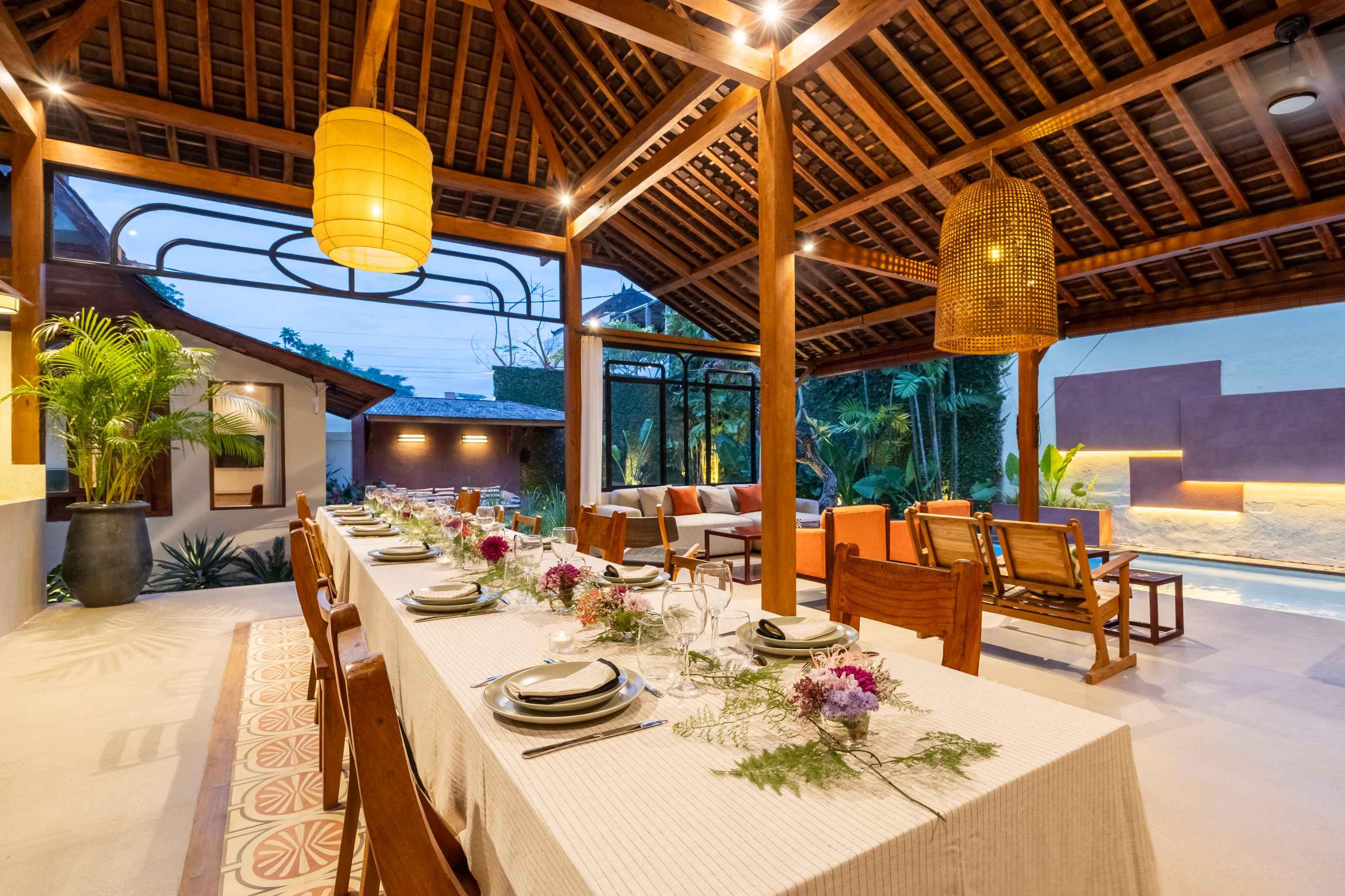 Open living pavilion and pool framed by tropical greenery at Bambu