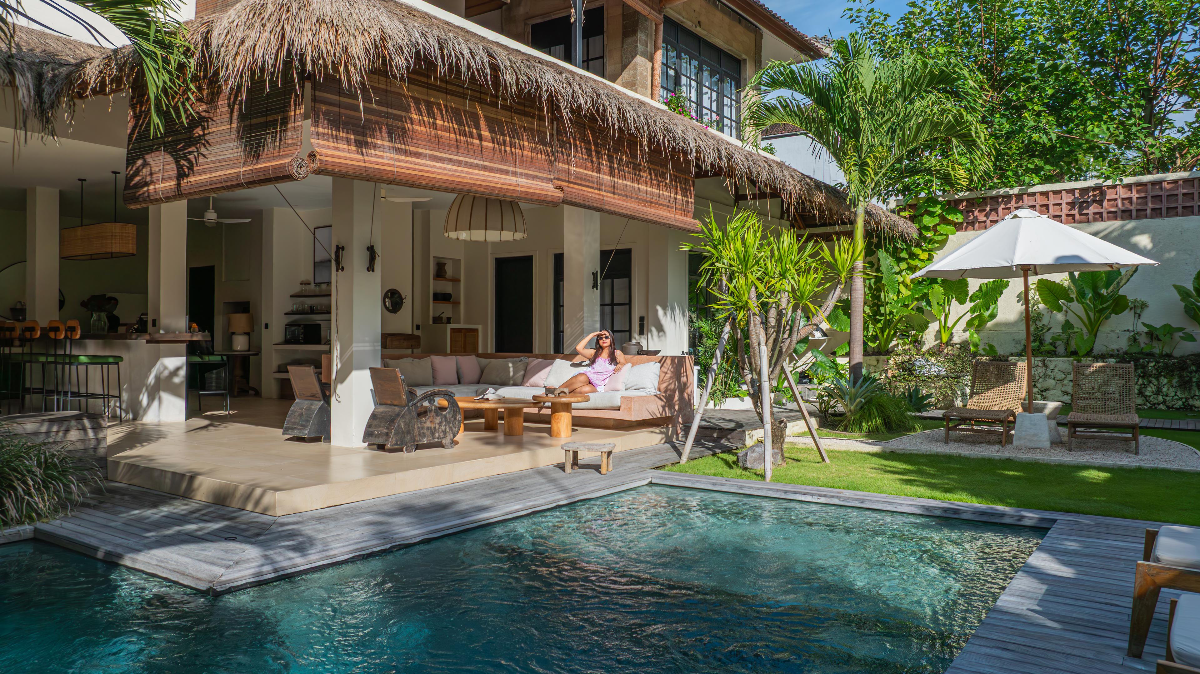Open living pavilion and pool framed by tropical greenery at Bambu